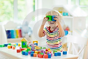 Kids toys. Child building tower of toy blocks