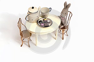 Kids toys. Set of toy furniture table with chairs. little bunny drinks tea.