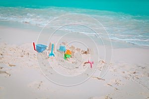 Kids toys on tropical beach, family vacation concept