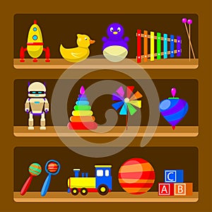 Kids toys on wood shop shelves isolated on background. Set of vintage rubber toy beanbag, baby rattle, robot, rocket, ball, truck