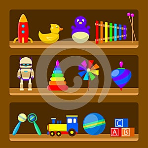 Kids toys on wood shop shelves isolated on background. Set of vintage rubber toy beanbag, baby rattle, robot, rocket, ball, truck