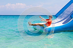 Kids on trampoline on tropical sea beach