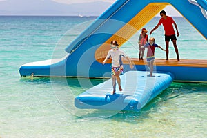 Kids on trampoline on tropical sea beach