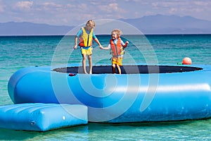 Kids on trampoline on tropical sea beach