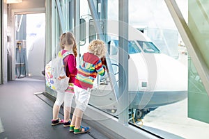 Kids travel and fly. Child at airplane in airport