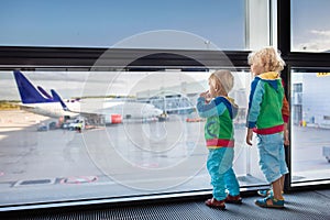 Kids travel and fly. Child at airplane in airport