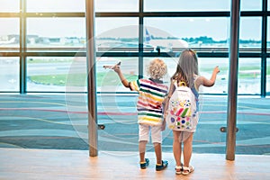 Kids travel and fly. Child at airplane in airport