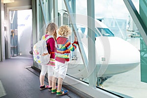 Kids travel and fly. Child at airplane in airport