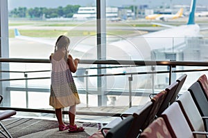 Kids travel and fly. Child at airplane in airport