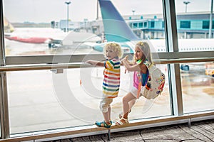 Kids travel and fly. Child at airplane in airport