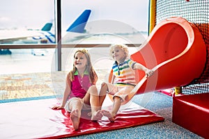 Kids travel and fly. Child at airplane in airport