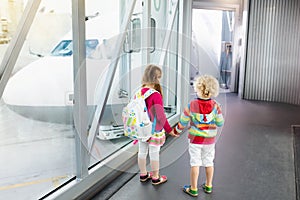 Kids travel and fly. Child at airplane in airport