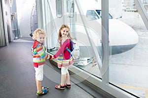 Kids travel and fly. Child at airplane in airport