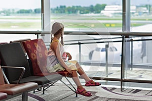 Kids travel and fly. Child at airplane in airport