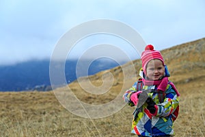 Kids travel- little girl hiking in winter mountains