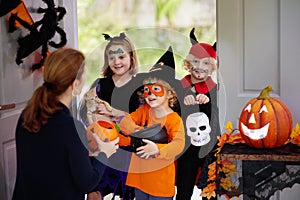 Kids trick or treat. Halloween. Child at door