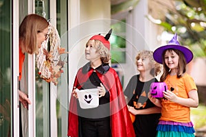 Kids trick or treat. Halloween. Child at door