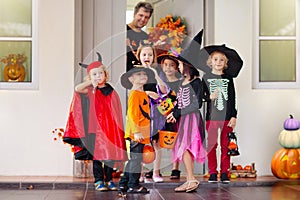 Kids trick or treat. Halloween. Child at door