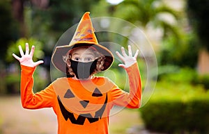 Kids trick or treat. Halloween in face mask