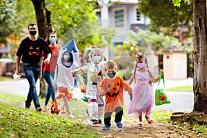 Kids trick or treat. Halloween in face mask