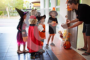 Kids trick or treat. Halloween. Child at door photo
