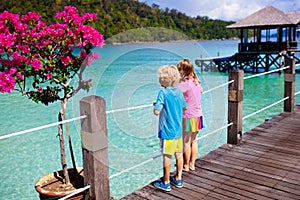 Kids on tropical beach. Child on resort jetty