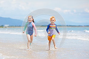 Kids on tropical beach. Children playing at sea