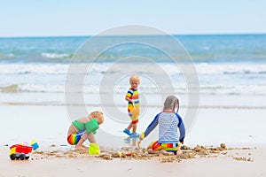 Kids on tropical beach. Children playing at sea