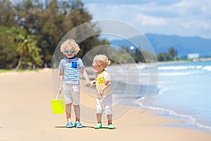 Kids on tropical beach. Children playing at sea