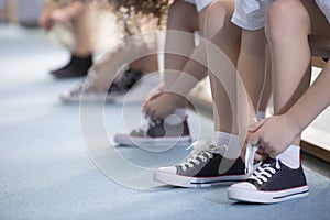 Kids tying sport shoes close-up