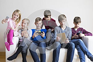 Kids using their gadgets photo