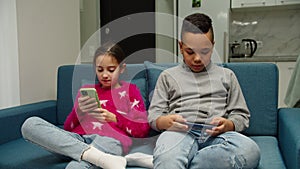 Kids using mobile app, playing game, checking social media at home