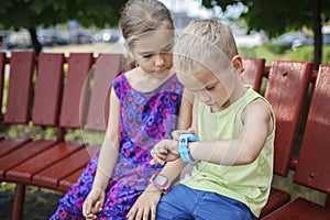 Kids using smartwatches with interest, care and parents control, new technology for children