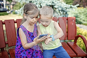 Kids using smartwatches with interest, care and parents control, new technology for children