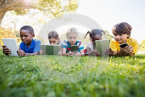 Kids using technology during a sunny day