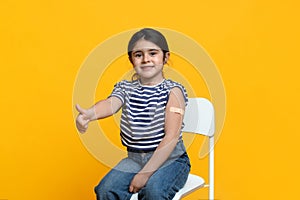 Kids Vaccination. Vaccinated Little Girl Gesturing Thumb Up After Covid-19 Vaccine Injection