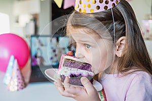 Kids virtual birthday,home party.Girl eating piece of cake.Online conference,video call in laptop,computer.Friends on screen,