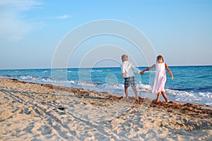 Kids walking along the beach together