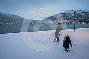 Kids walking in a deep snow