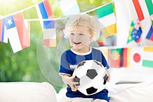 Kids watch football game. Child watching soccer.