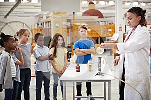 Kids watching lab technician carry out a science experiment