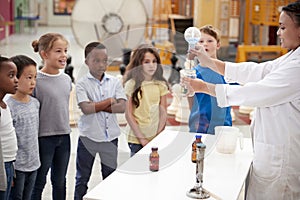 Kids watching lab technician carry out a science experiment