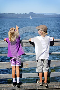 Kids watching a sailboat