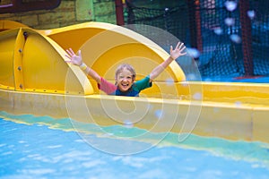 Kids on water slide. Family in aqua theme park