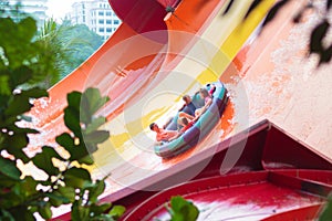 Kids on water slide. Family in aqua theme park