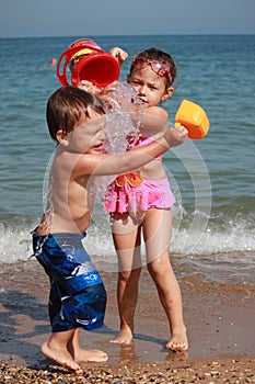 Kids watering on the beach