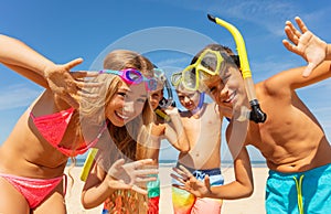 Kids waving hands wearing scuba snorkeling masks