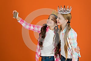 Kids wear golden crowns symbol princess. Warning signs of spoiled child. Avoid raising spoiled kids. Girls taking selfie