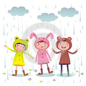 Kids wearing colorful raincoats and boots playing on rainy day
