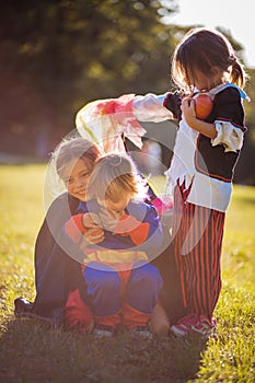 Kids wearing Halloween suits and playing in the park